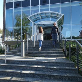 Foto der Eingangstreppe der Zentralbibliothek mit zwei Bibliotheksmitarbeitern